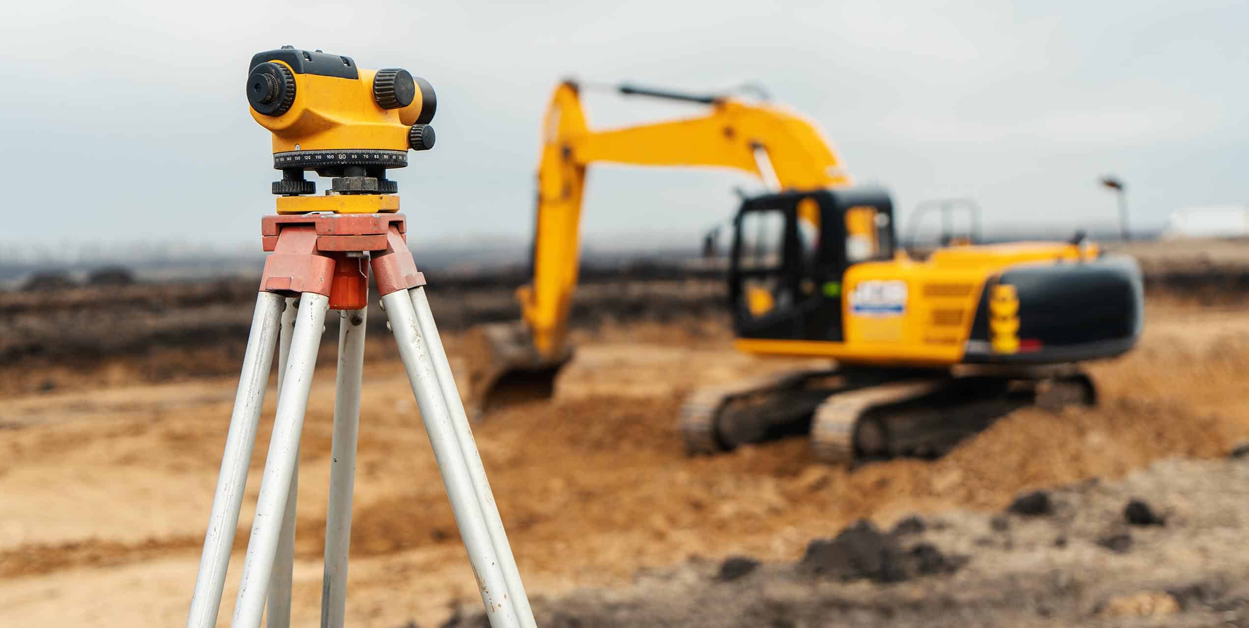 Baustelle mit Messgerät und Bagger