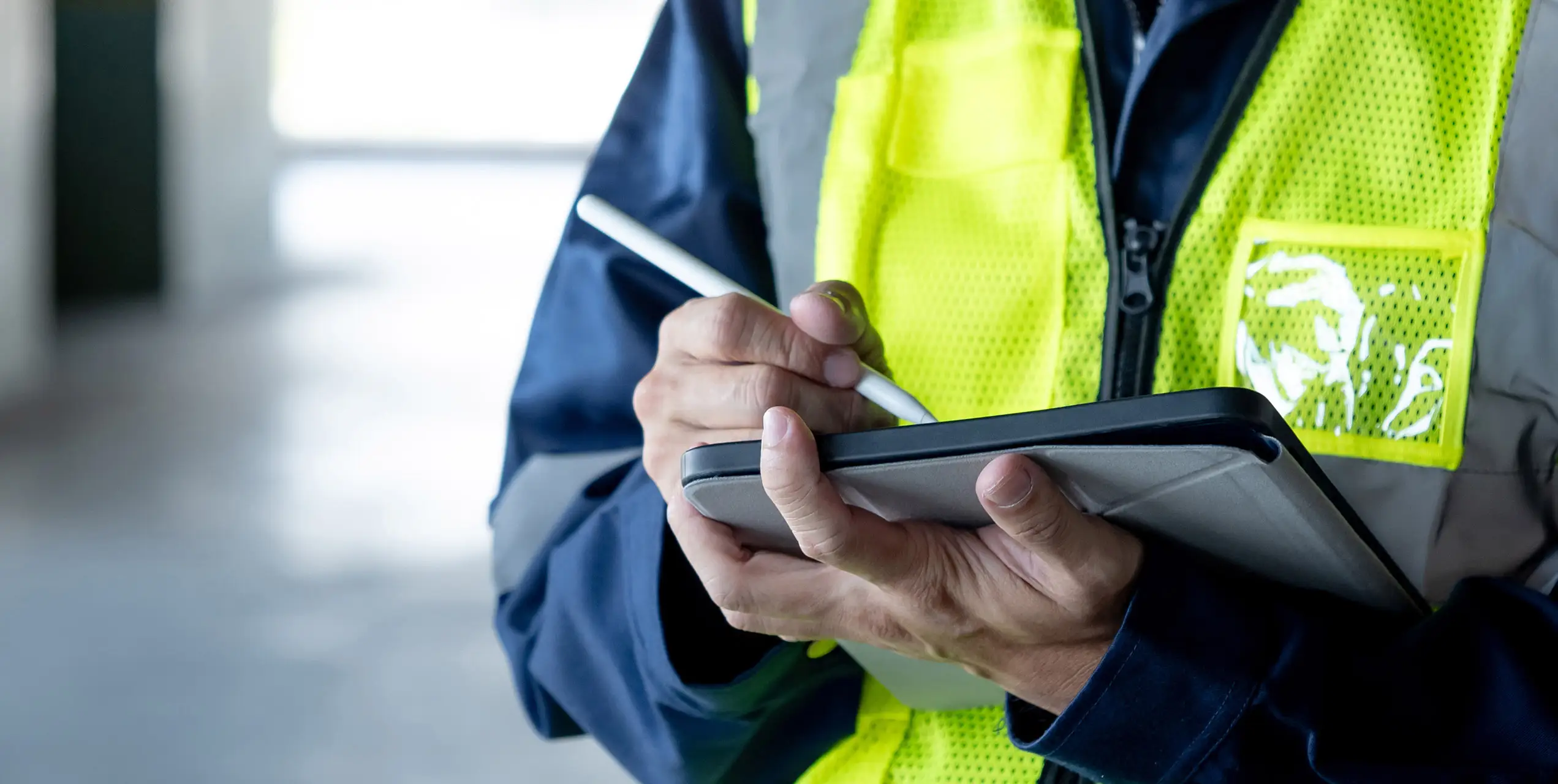 Ein Techniker mit Tablet beim Ausfüllen eines Wartungsprotokolls